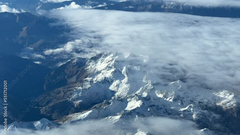 Aerial view from a jet cockpit flying at 9000m high of the Pyrenees Mountains flying southbound from France to Spain in a cold autumn moorning with some snow at the tops and clouds. Aerial view from a jet cockpit flying at 9000m high of the Pyrenees Mountains flying southbound from France to Spain in a cold autumn moorning with some snow at the tops and clouds.