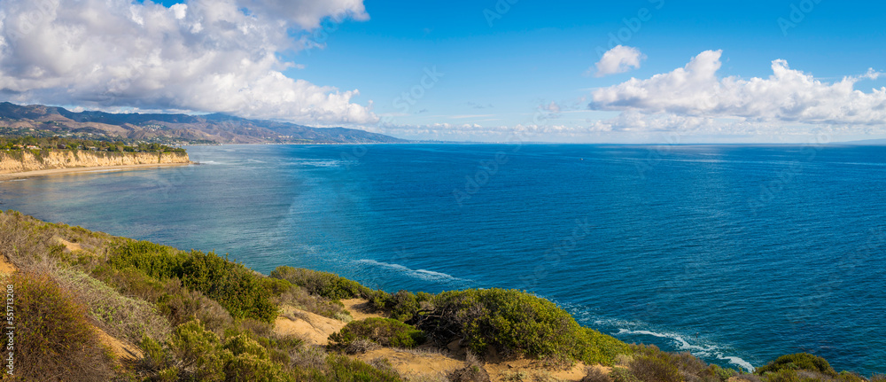 Fototapeta premium Point Dume promontory seascape and dramatic cloudscape on the coast of Malibu, California, with the view of Paradise Cove Beach in Laguna Point to Latigo Point Area of Special Biological Significance