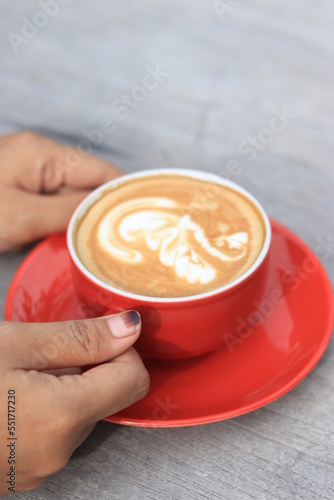 a glass of hot cafe latte with latte art in the morning