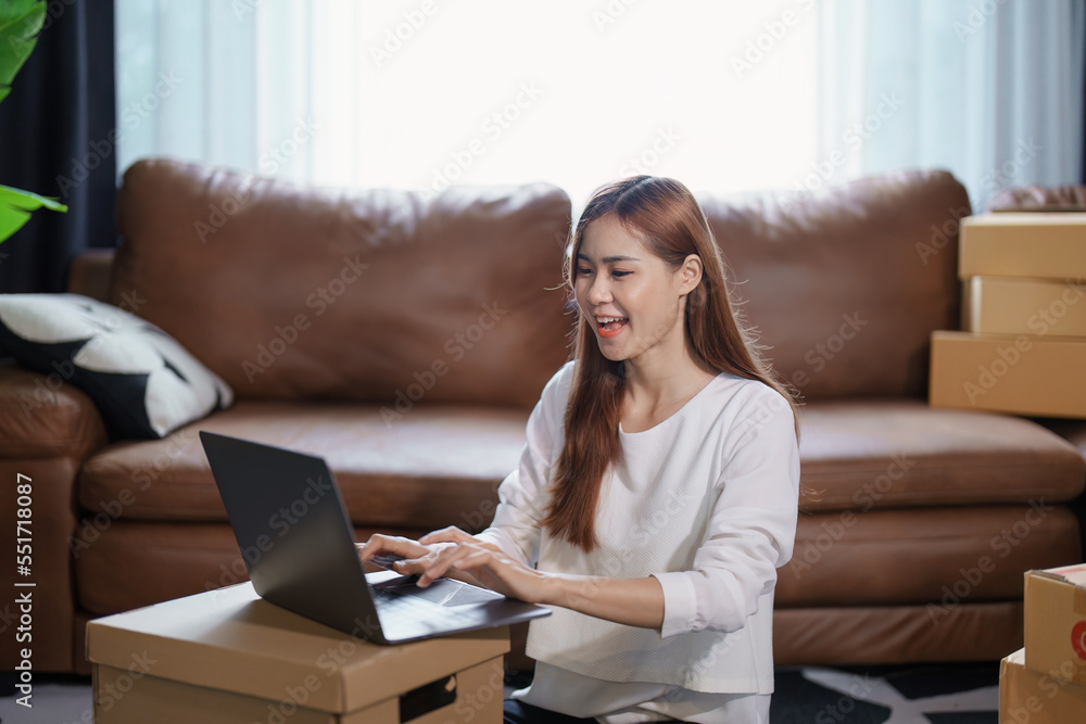 Starting small business entrepreneur of independent Asian female online seller packing products to send to customers and SME delivery concept Starting small business entrepreneur of independent Asian female online seller packing products to send to customers and SME delivery concept
