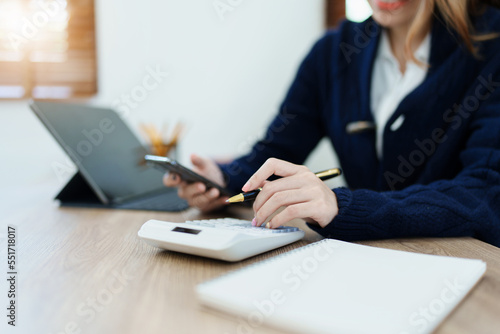 financial, Planning, Marketing and Accounting, portrait of Asian employee checking financial statements using and calculator, tablet computer and smart phone at work