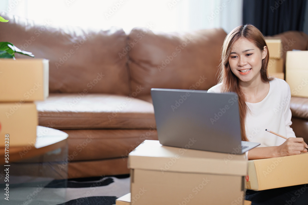 Starting small business entrepreneur of independent Asian female online seller packing products to send to customers and SME delivery concept Starting small business entrepreneur of independent Asian female online seller packing products to send to customers and SME delivery concept