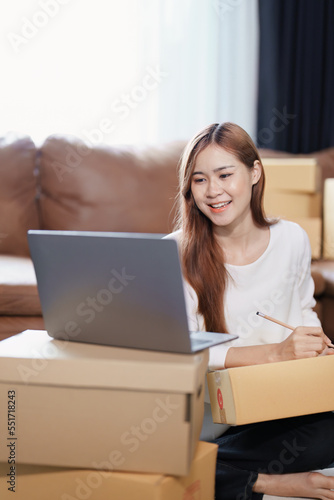 Starting small business entrepreneur of independent Asian female online seller packing products to send to customers and SME delivery concept © Jirapong