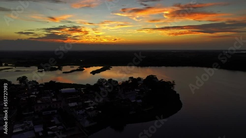  HQ Aerial footage - Drone moving around the town with sunset reflection on the water - Dark scene