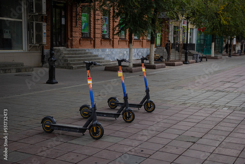 Three unoccupied electric scooters on the street