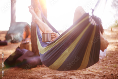 girl lying in a hammock on the camping site.