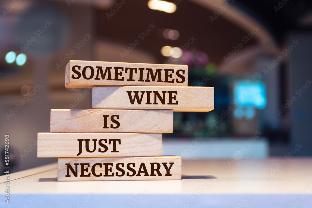 Wooden blocks with words 'Sometimes Wine Is Just Necessary'.