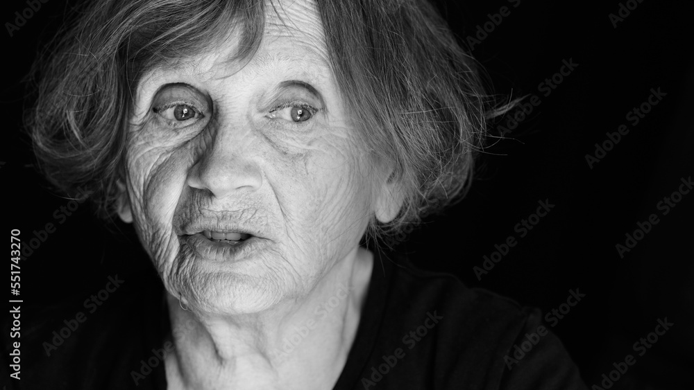 Portrait of senior caucasian woman talking on black background