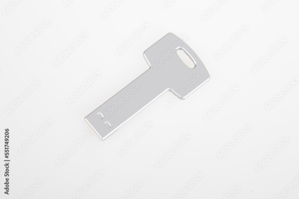 USB Key silver Flash Drive Stick Memory on white desk background USB Key silver Flash Drive Stick Memory on white desk background