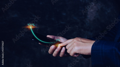 Businessman holding touching smartphone with growing virtual hologram stock, invest in trading. planning and strategyto that has grown exponentially rapidly from 0 percent to 100 percent sales.