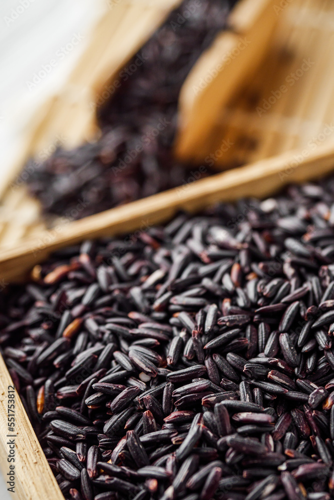 raw fresh black rice on wooden rustic background raw fresh black rice on wooden rustic background