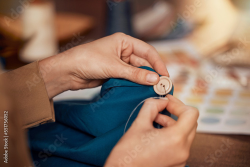 Womab, hands and sewing clothes button in studio for designer wear, fashion garment and creative fabric design. Tailor, boutique startup and fashion designer hand or seamstress working on clothing photo