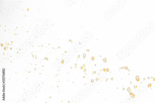 Orange  lemon juice or oil lubricant splash  liquid gold yellow drink drops. Fruit beverage water elements in line form . Fresh splashing and flowing jets  black background isolated freeze motion