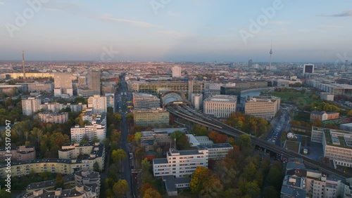 Aerial panoramic view of autumn metropolis at dusk. S Bahn train leaving modern Berlin Hauptbahnhof station. Berlin, Germany photo