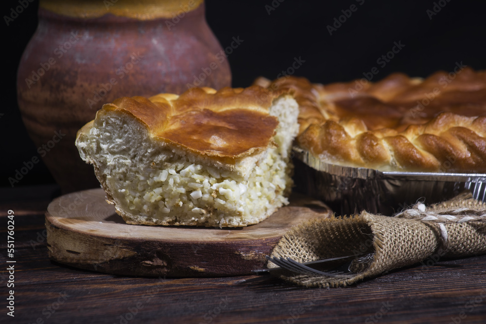 Russian type of pirog stuffed with rice,  hard-boiled egg. Homemade pie stuffed with egg and rice - obrazy, fototapety, plakaty 