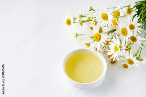 Fototapeta Naklejka Na Ścianę i Meble -  aromatic chamomile essential oil on a white background