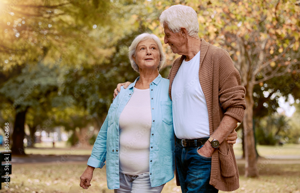 Senior couple, bonding or walking in nature park, city garden or public environment in relax exercise, mobility or retirement break. Smile, happy woman or talking elderly man in hug and weekend date