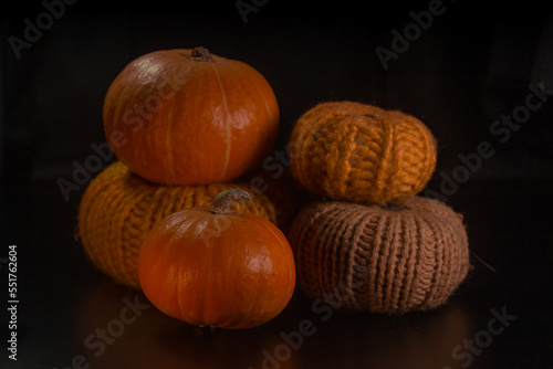 Yellow-orange pumpkins on a black background the concept of Halloween and the autumn harvest of pumpkin close-up copyspace from above