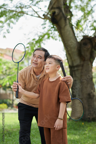 Boy and Grandfather Playing Badminton photo