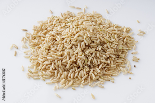 raw unpolished rice on a white acrylic background