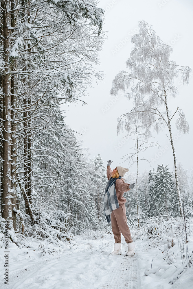 Winter.woman walks through winter snowy forest. Mental and physical health. Unity with nature.travel outdoors, hiking, spending time outdoors,winter travel,slow life,christmas forest.