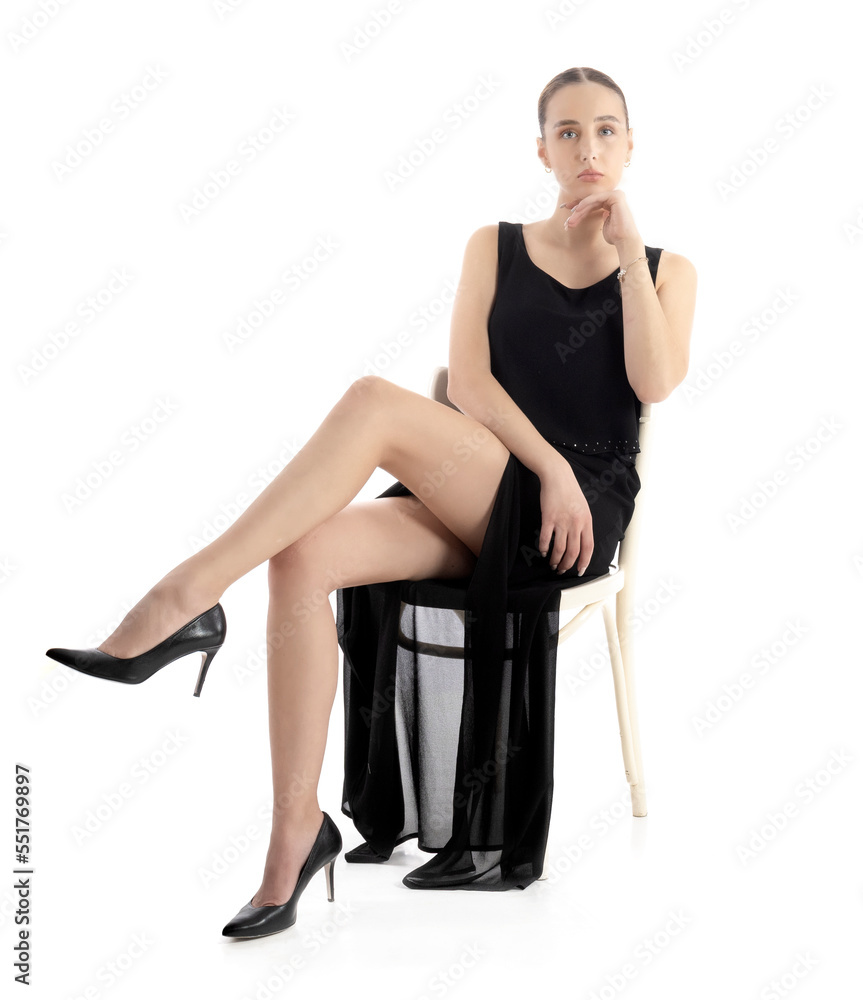 Beautiful model in a black elegant dress. Studio session on a white background Beautiful model in a black elegant dress. Studio session on a white background