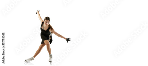 Photography Portrait of flexible young girl, female figure skater in black stage costume skating isolated over white background
