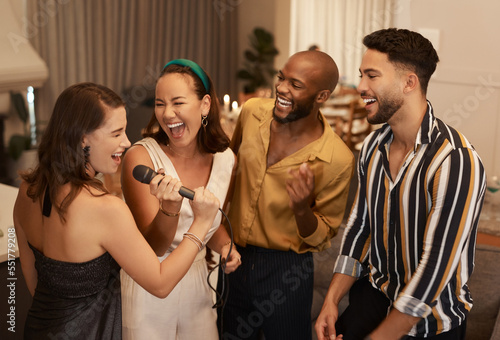 Friends, karaoke party and happy celebration together, dancing and fun reunion in restaurant lounge. Dance, singing happiness and group of people celebrate birthday event, new year or social comedy