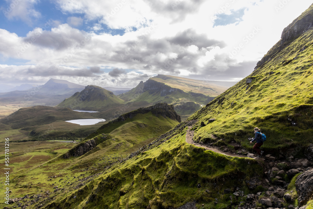 Woman hiking on Quiraing.It is a geological formation on the Scottish Isle of Skye and a hiker's paradise