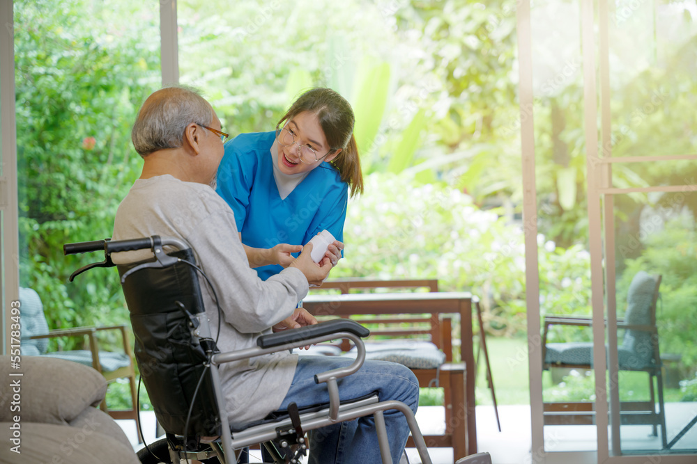 Asian young woman nurse pills with help prescribes medicine to older disabled patient on wheelchair when elderly senior man patient's time to go home at nursing home care. Medicine and health care Asian young woman nurse pills with help prescribes medicine to older disabled patient on wheelchair when elderly senior man patient's time to go home at nursing home care. Medicine and health care