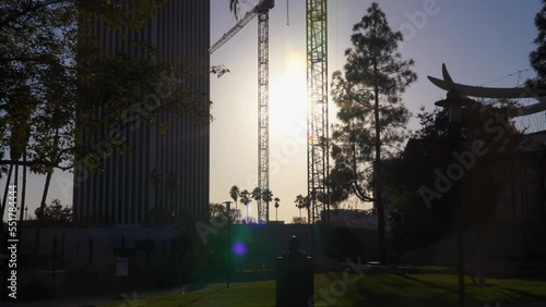 Walking through the Los Angeles County Museum of Art (LACMA) during sunset with buildings and infrastructure in the background on a sunny California day. photo