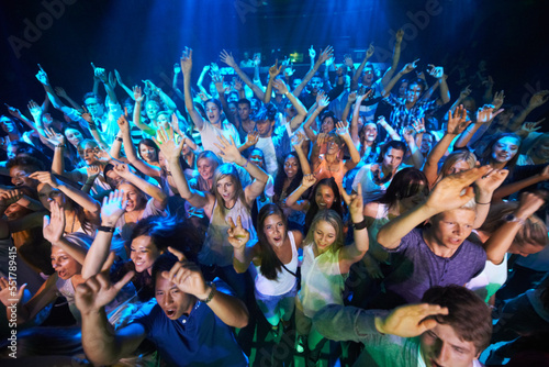 Dance, music and party with audience at concert for rock, festival or disco with live band performance. Celebration, social and nightclub show with crowd of fans listening for rave or new year event