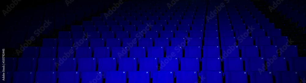 Fototapeta premium empty cinema theater with blue seats in the dark