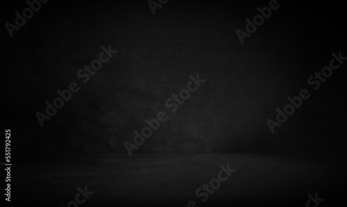Empty dark three dimensional room with black concrete wall and floor and a low lighting