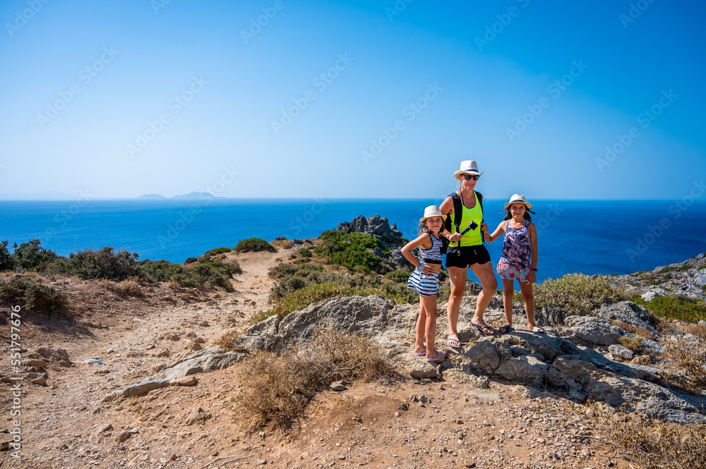 Family with kids tourists standing above Preveli beach, Crete, Greece.