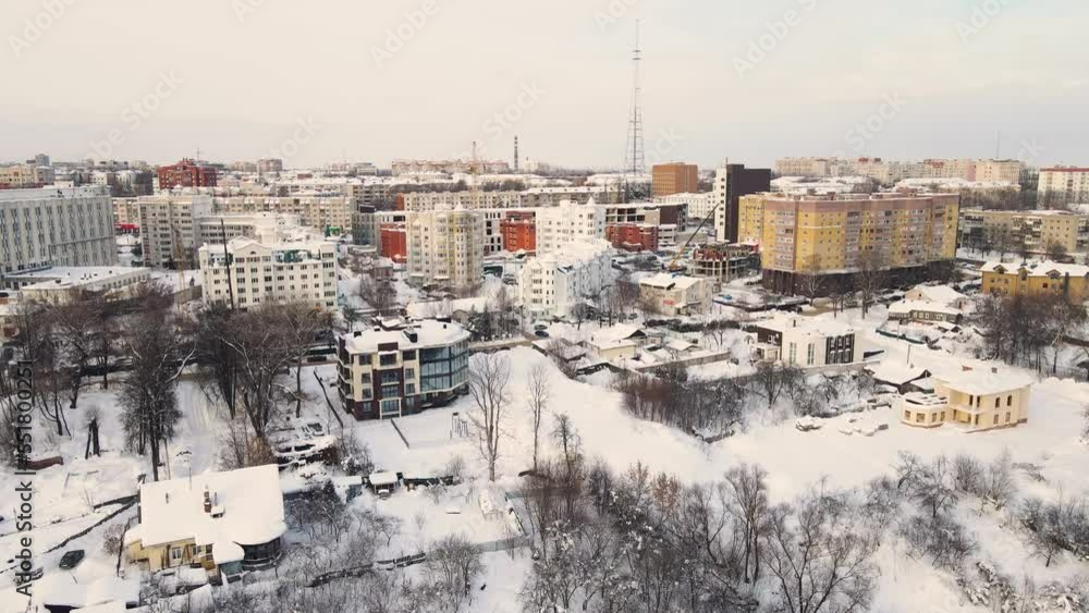 Bird's eye view of a snow-covered urban residential area. New buildings in a modern metropolis. Solution of the housing problem. City of Vladimir, Oktyabrsky district. UHD 4K. Bird's eye view of a snow-covered urban residential area. New buildings in a modern metropolis. Solution of the housing problem. City of Vladimir, Oktyabrsky district. UHD 4K.
