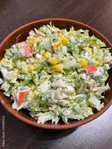 large vertical photo. homemade food. salad with Chinese cabbage and crab imitation. balanced salad. healthy food. eco. bio. Russian traditional salad for the holidays.
