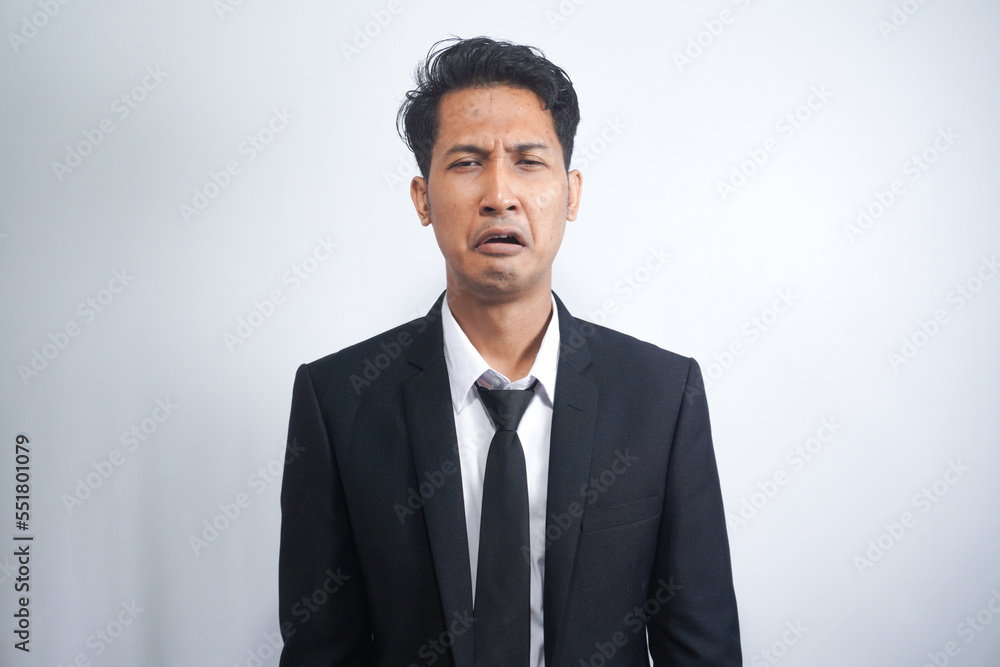 Close-up of miserable man in suit, crying and sobbing, feeling sad, standing against white background Close-up of miserable man in suit, crying and sobbing, feeling sad, standing against white background