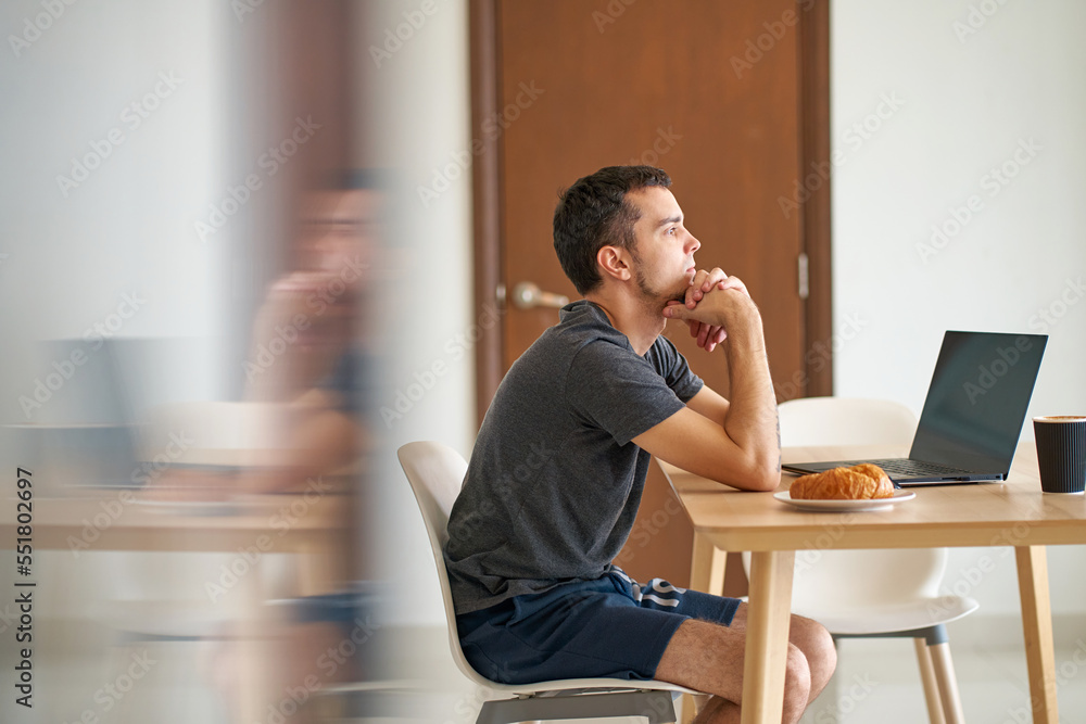 The guy strained to think as he read the news while sitting at his laptop The guy strained to think as he read the news while sitting at his laptop