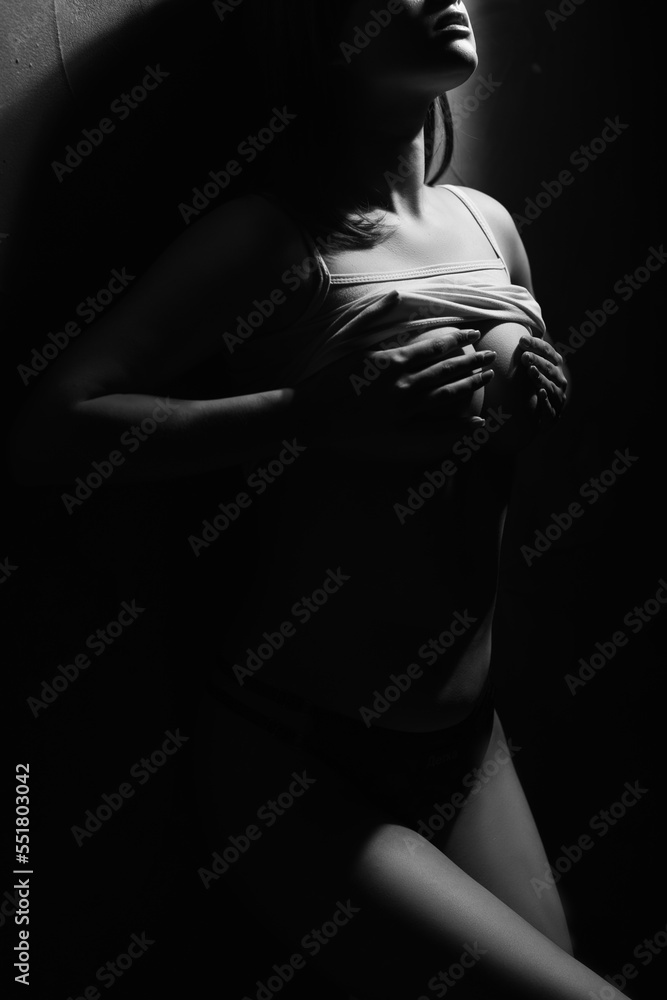 Naklejka premium woman covers her breast. perfect body girl, black and white photo