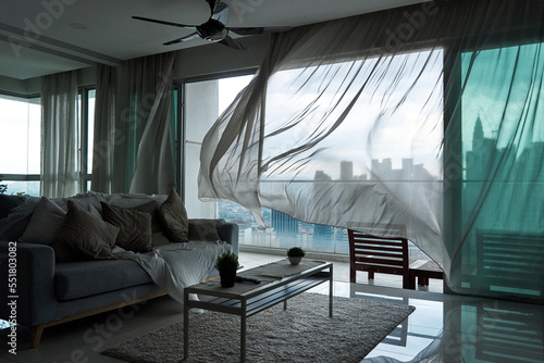 Photography The wind rustles the curtain of the panoramic window with a cityscape