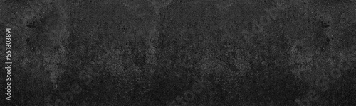 Black concrete wall. Dark gray rough cement panoramic distressed texture. Gloomy grunge textured long background