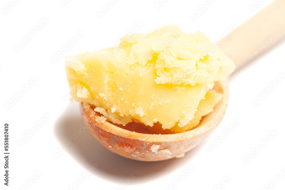Ghee in wooden spoon isolated on white background Ghee in wooden spoon isolated on white background