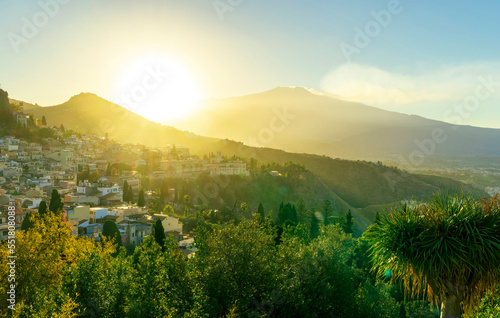 highland mediterranean travel landscape scenic picture from green garden to a beautiful mountain town in sunrise or sunset with trees in garden and amazing colorful sky
