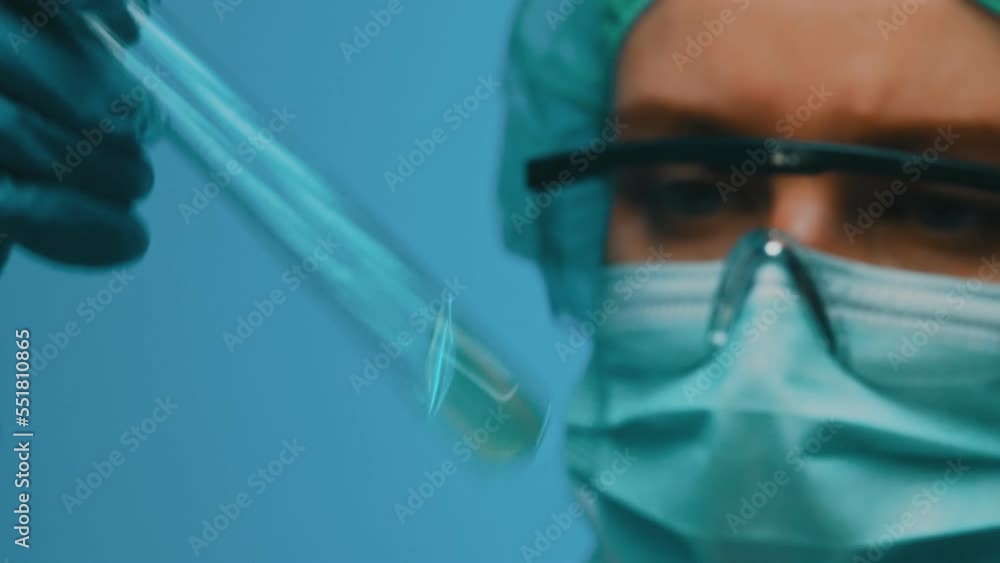 Woman in goggles and mask working with test tubes in laboratory. Woman in goggles and mask working with test tubes in laboratory.
