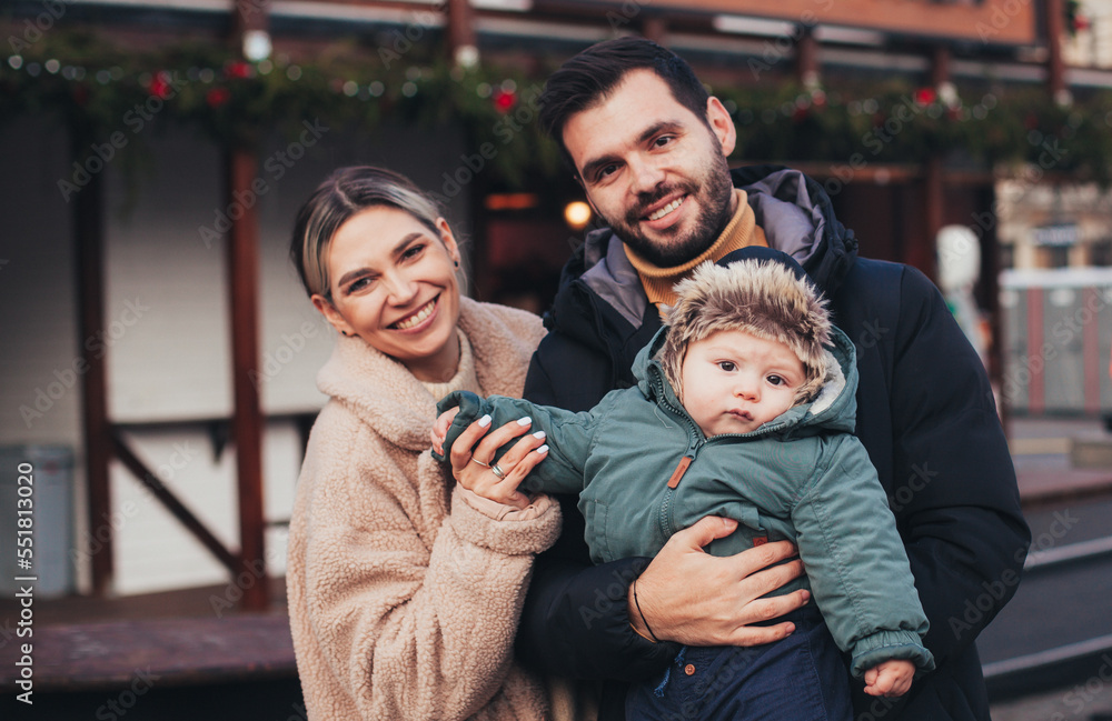 family on the street in christmas town family on the street in christmas town