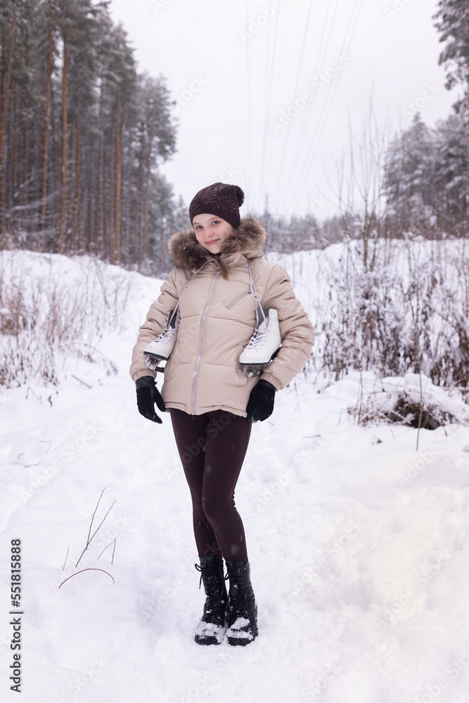 cute girl with skates on nature on winter day. cute girl with skates on nature on winter day.