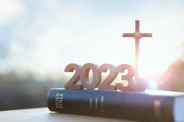2023 new year rising sun and sunrise and cross of jesus christ and holy bible
