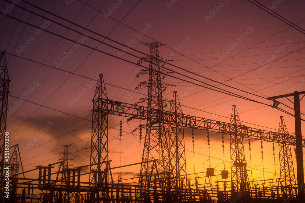 High voltage power plant at sunset, high voltage transmission tower.