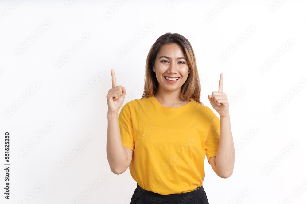 Hot asian pretty young woman smiling isolated on white, yellow t-shirt, pointing to copy space Hot asian pretty young woman smiling isolated on white, yellow t-shirt, pointing to copy space